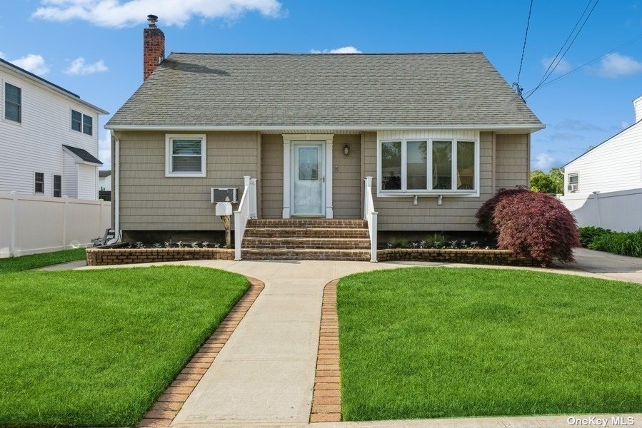 a front view of house with yard and green space