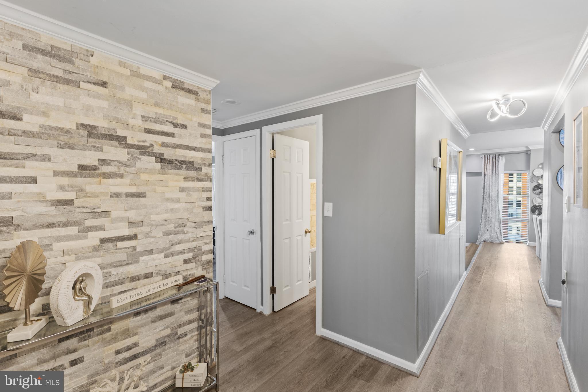 a view of a hallway with wooden floor and staircase