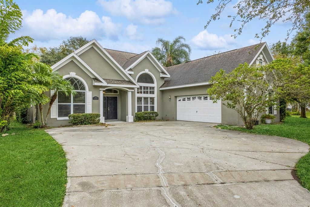 front view of a house with a yard and trees