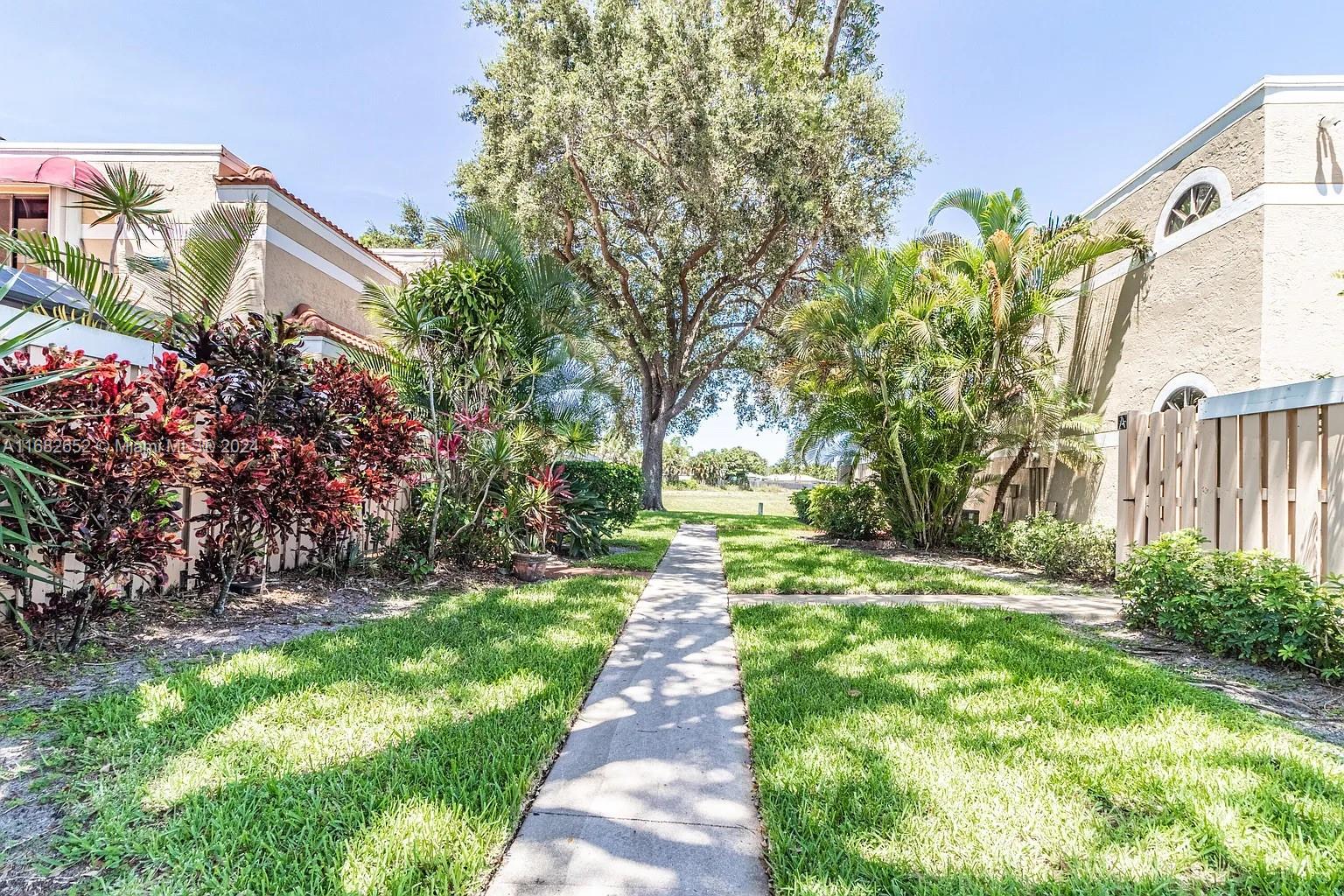 a pathway of a house with a yard