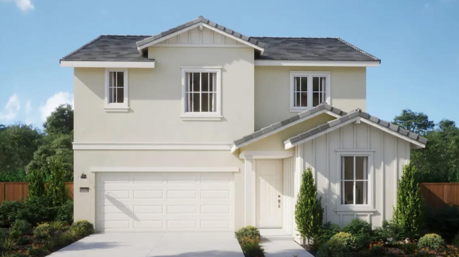 a white house with a small yard and a large window