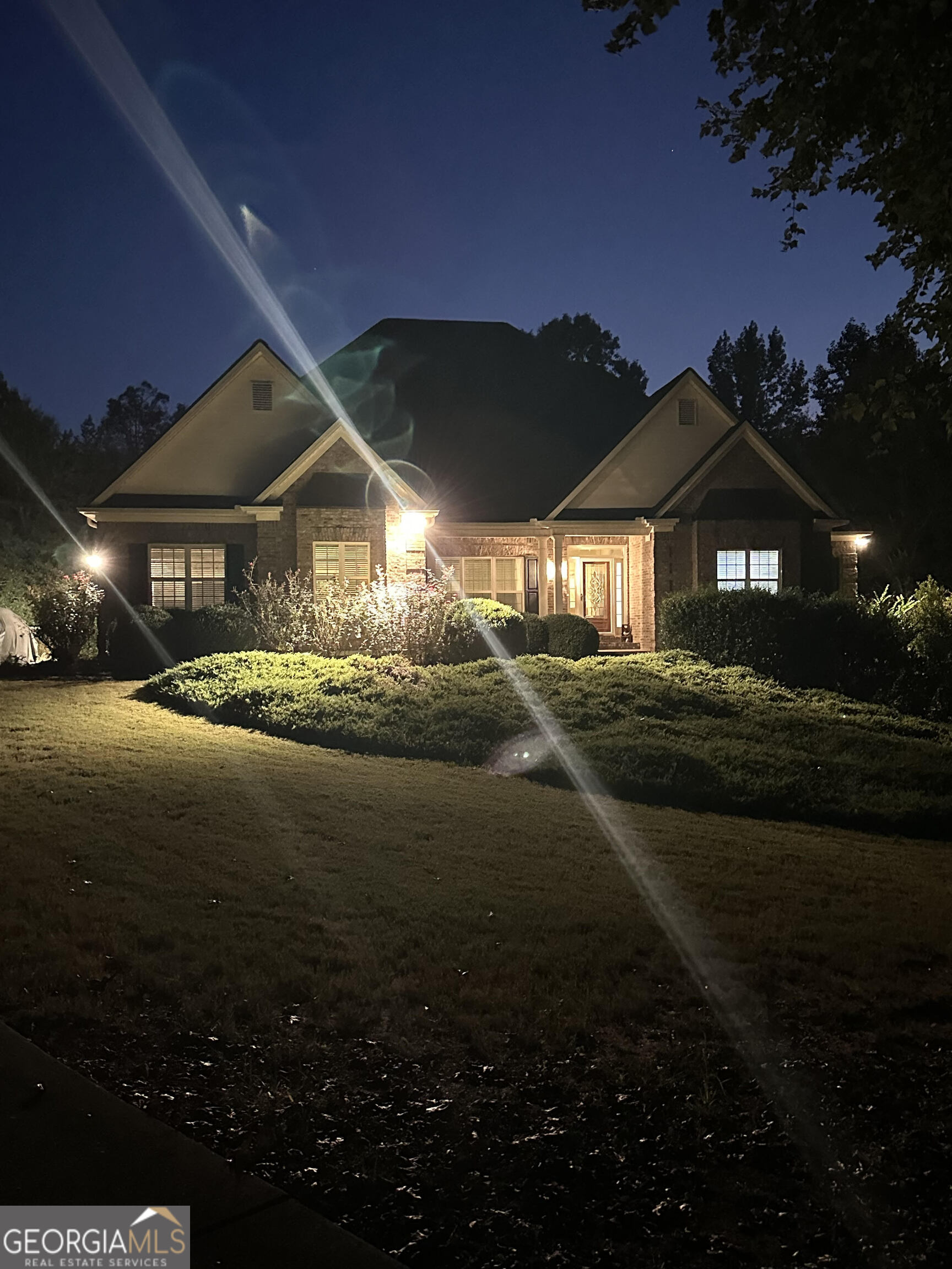 a front view of a house with a garden