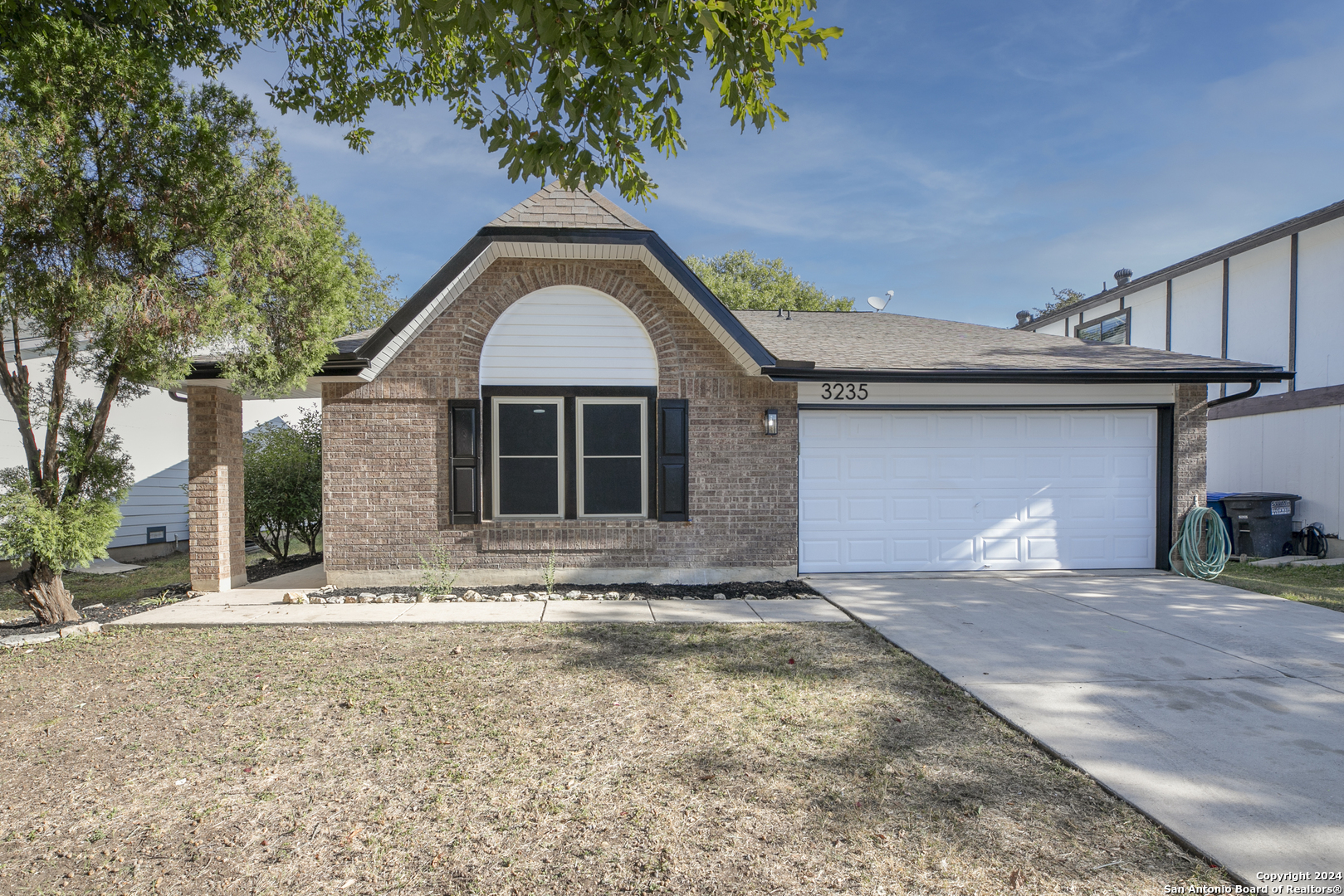 a front view of a house with a yard