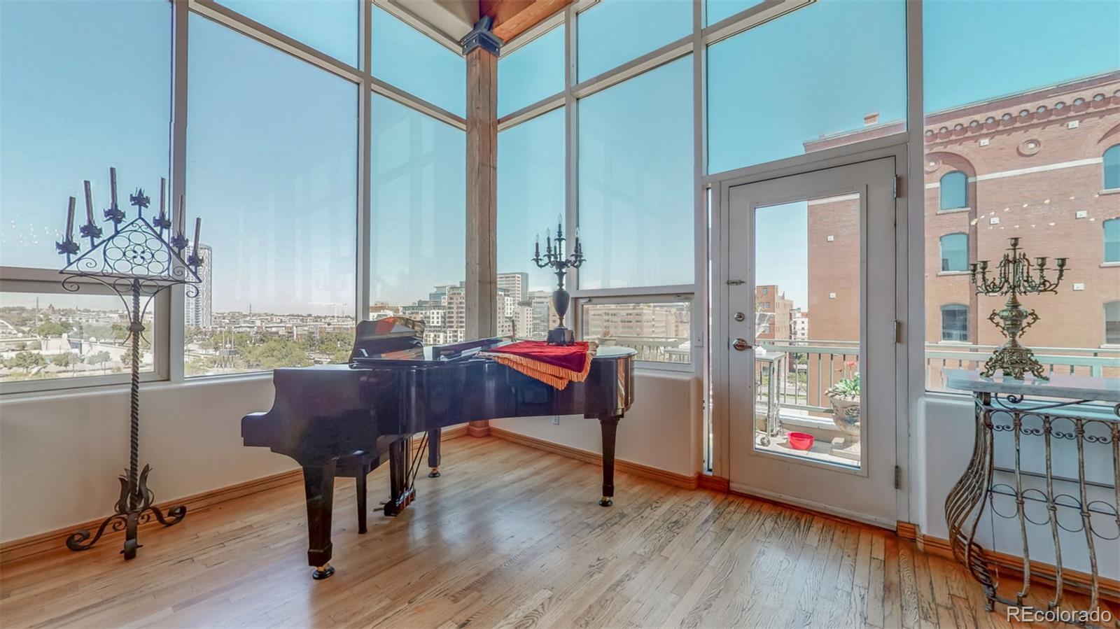 a living room with furniture a window and wooden floor