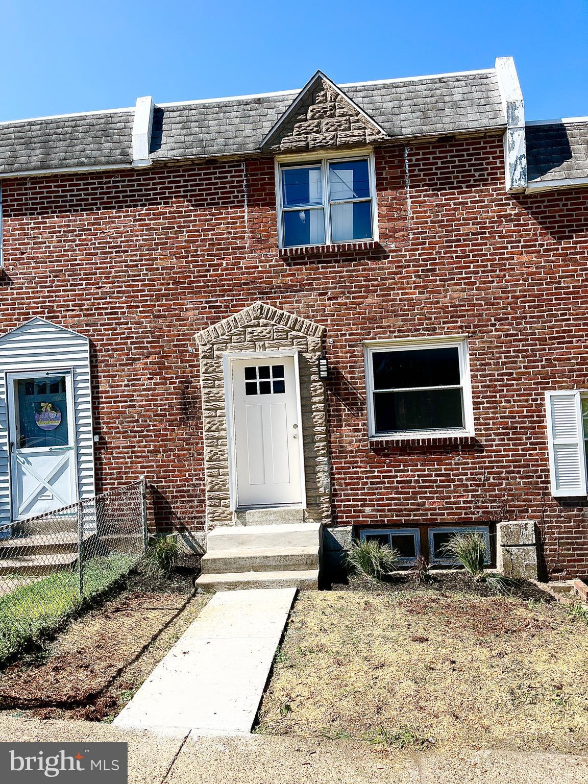 a brick house with a bench in front of it