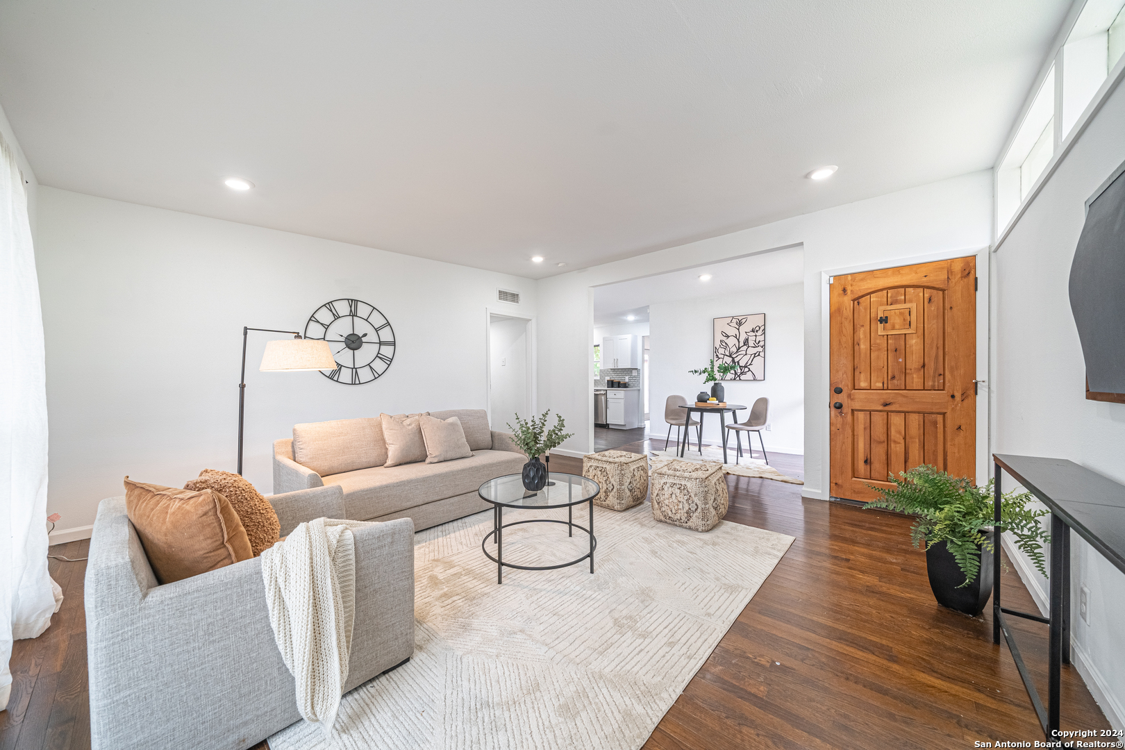 a living room with furniture and wooden floor