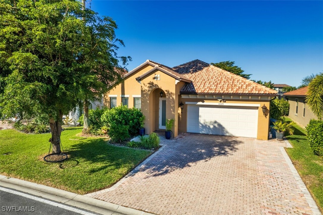 a front view of a house with a yard and garage