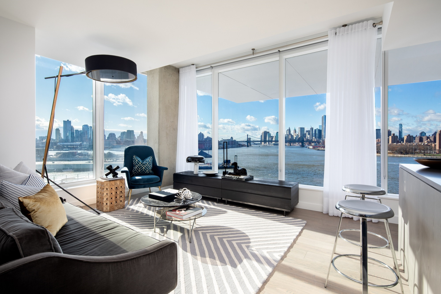 a living room with furniture and floor to ceiling windows