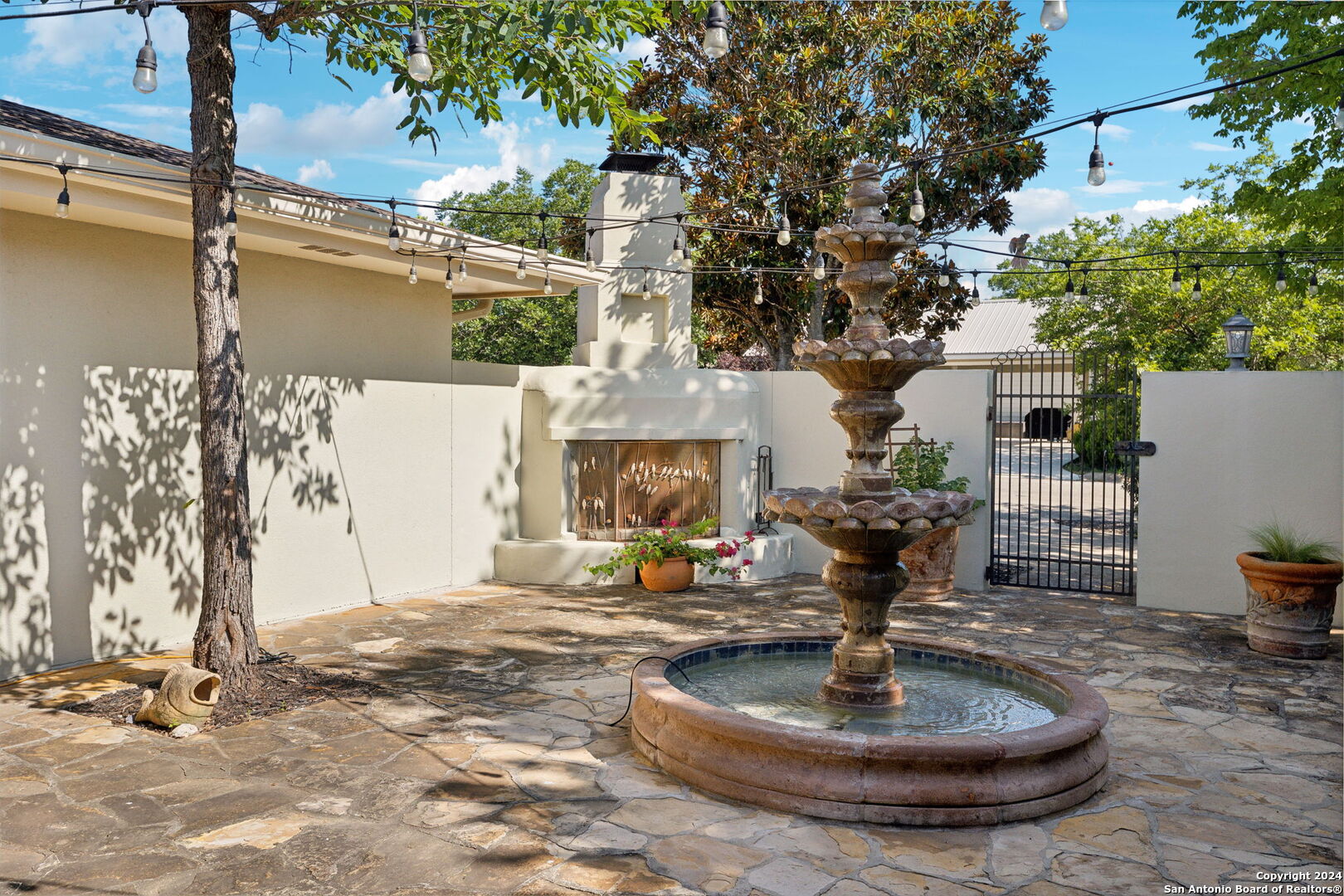 a view of a house with fountain bath tub and fire pit