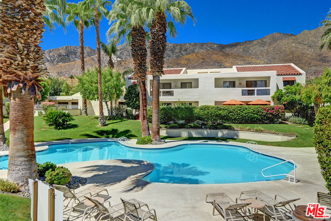 a view of a house with swimming pool and a yard