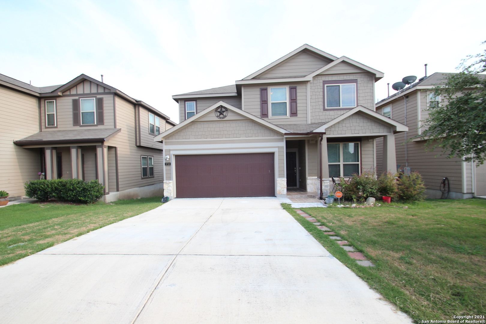 a front view of a house with a yard and garage