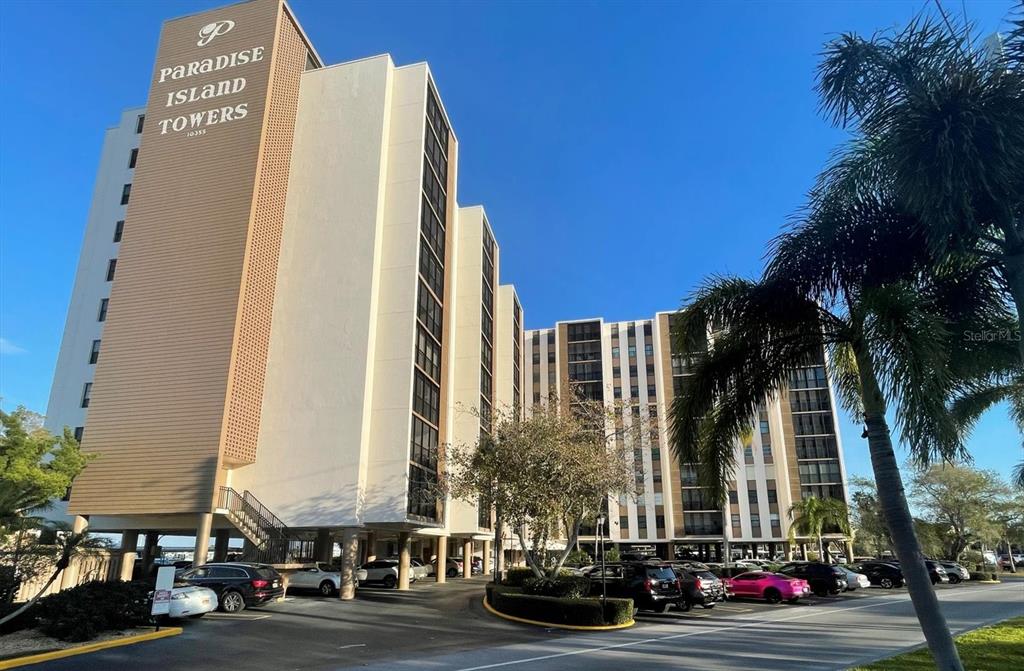 a view of a tall building next to a road