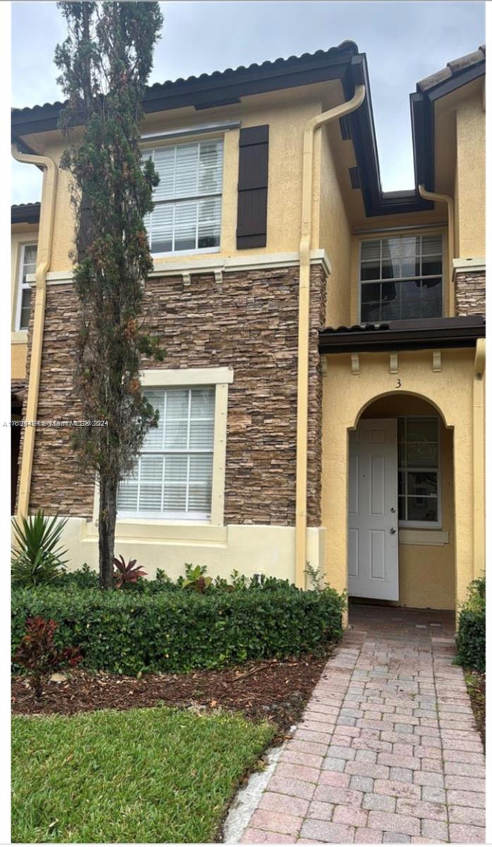 a front view of a house with a yard