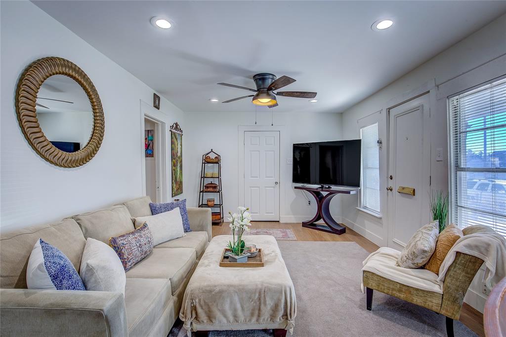 a living room with furniture a rug and a flat screen tv