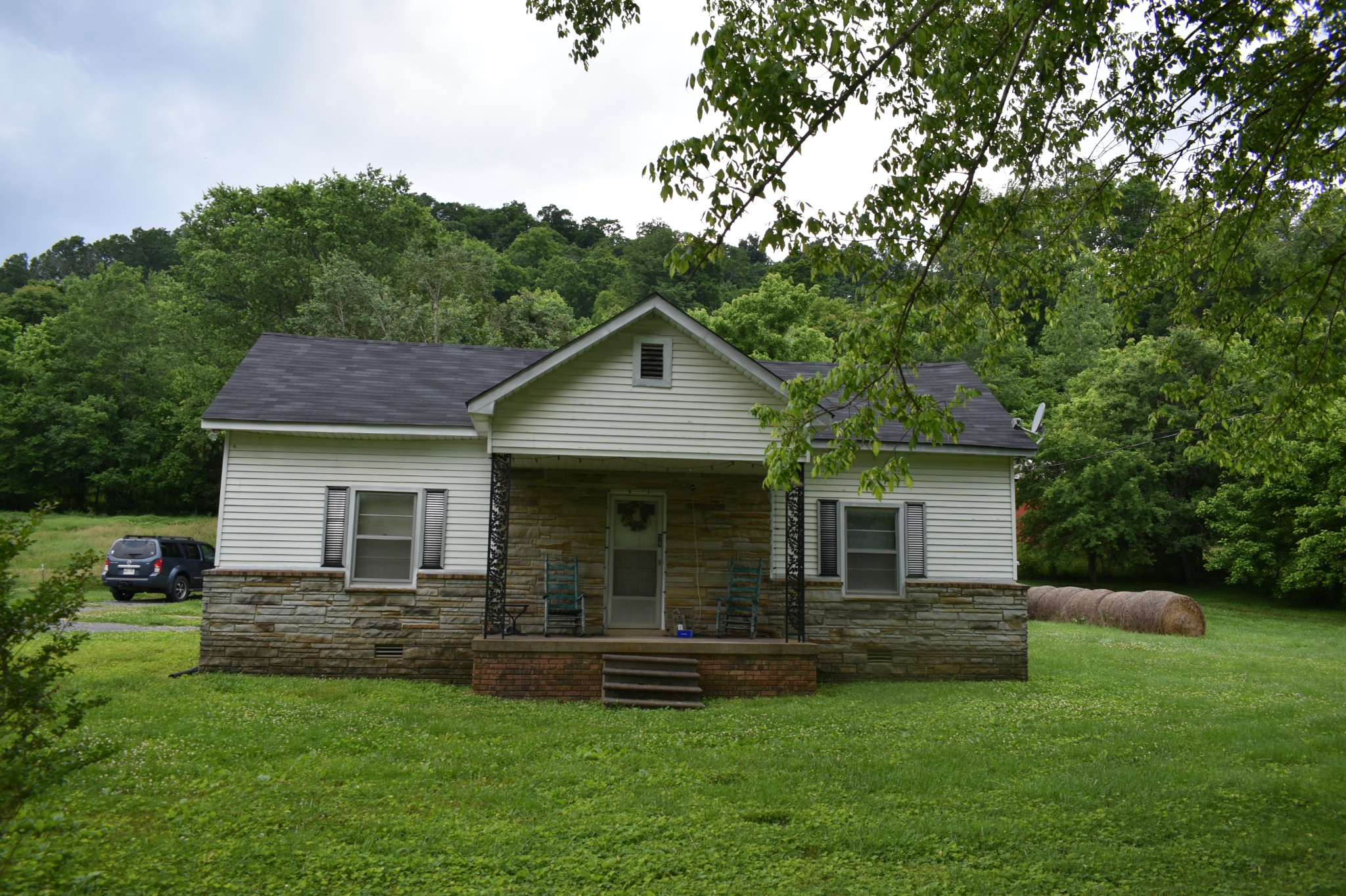 a front view of house with yard and green space