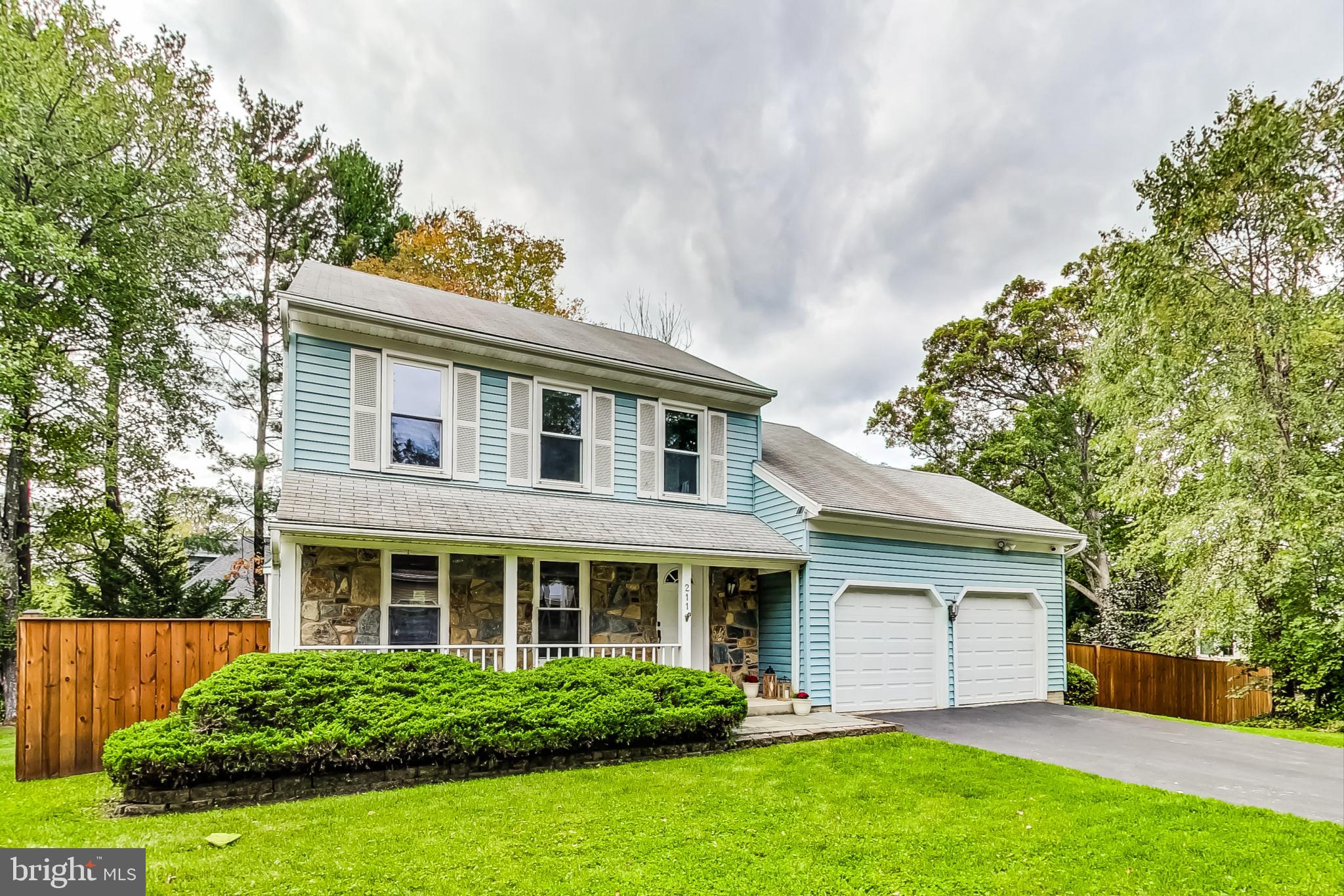 a front view of a house with a yard and potted plants