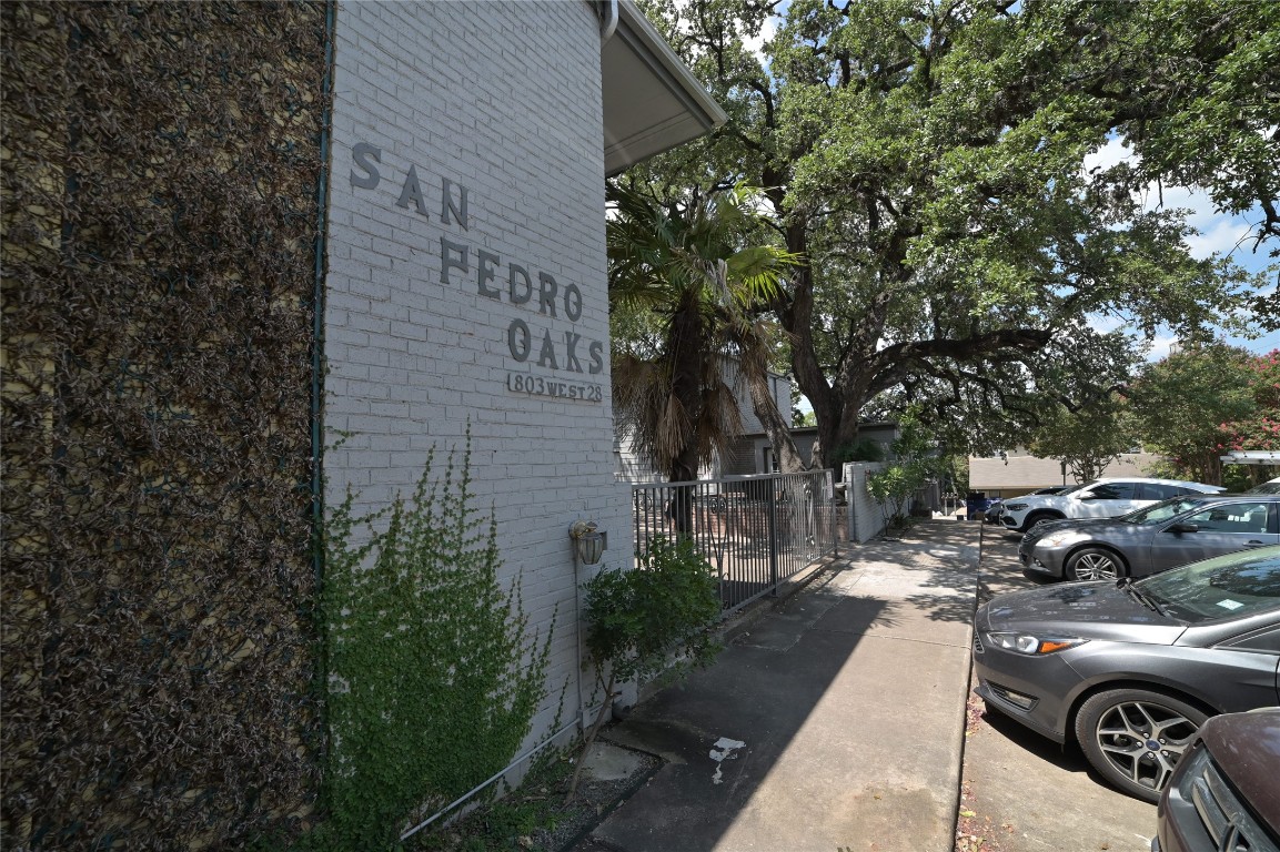 a couple of cars parked in front of a building