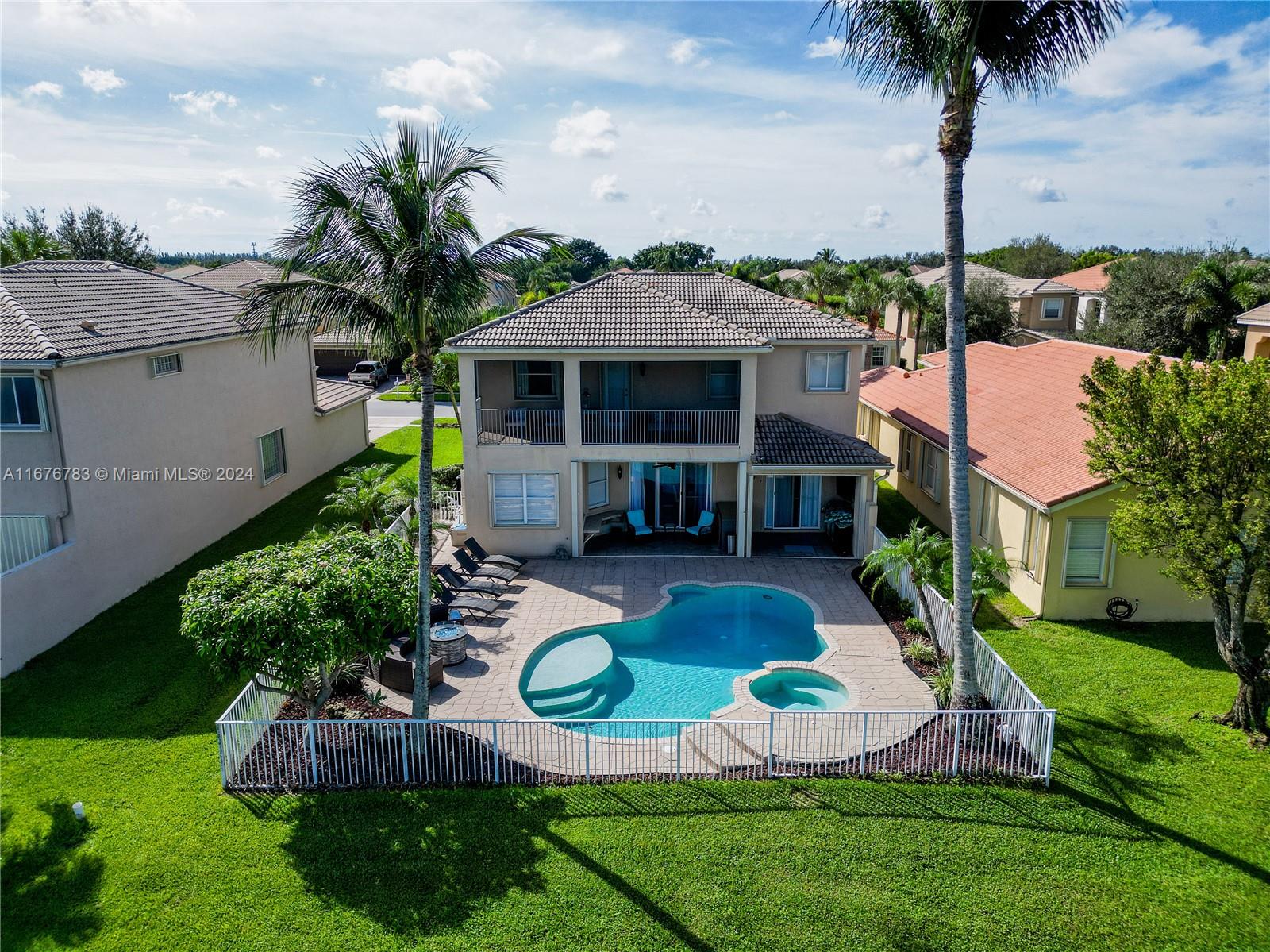 a aerial view of a house with swimming pool yard and outdoor seating