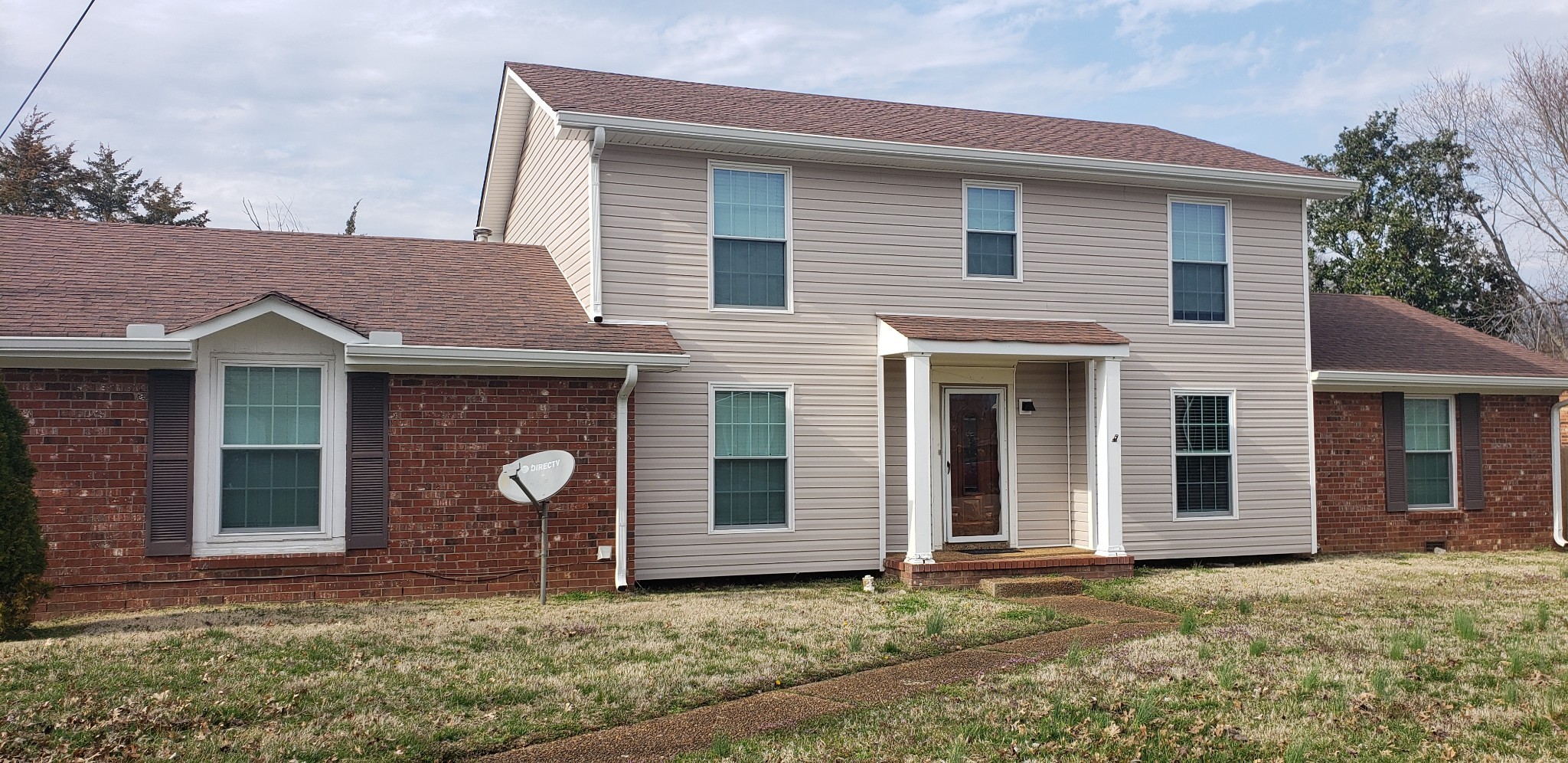 a front view of a house with a yard