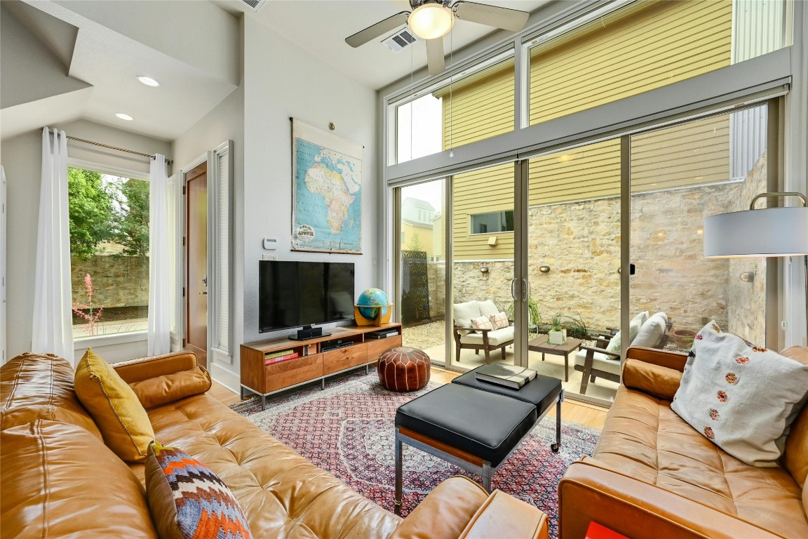 a living room with furniture and large windows