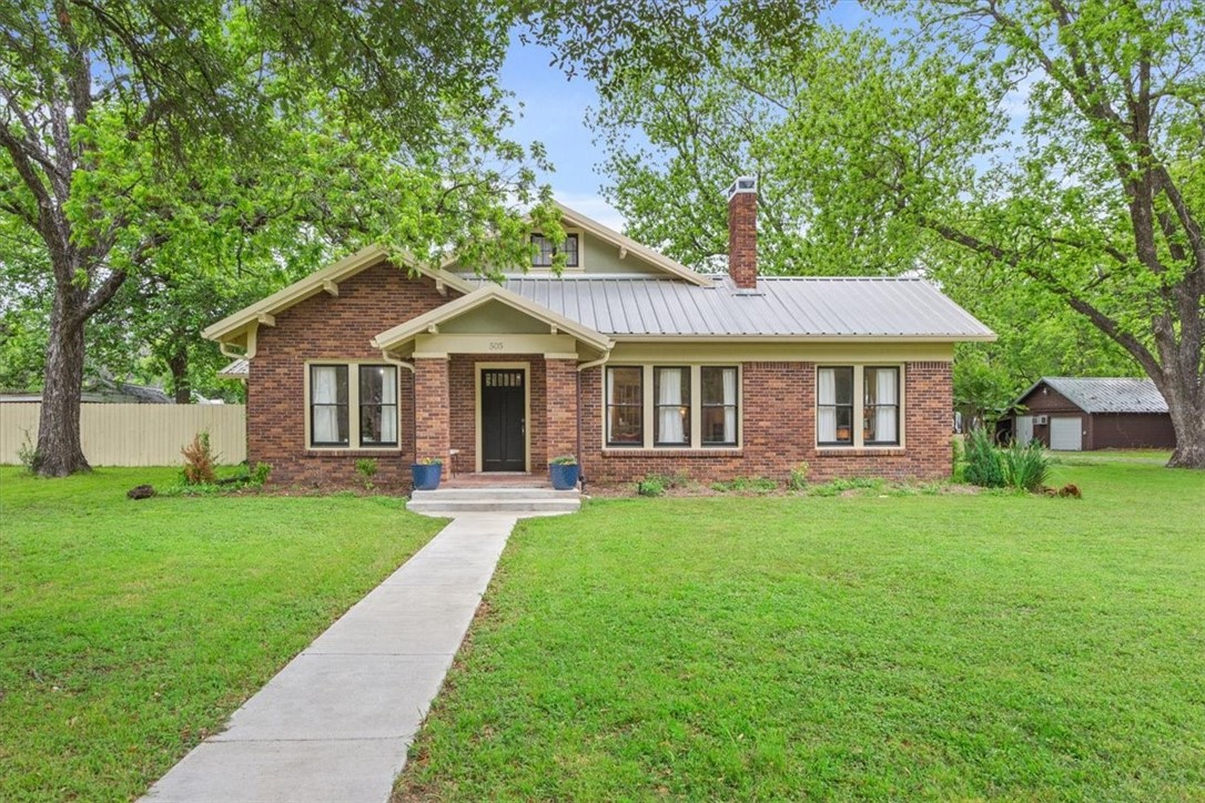 a front view of a house with a garden and porch