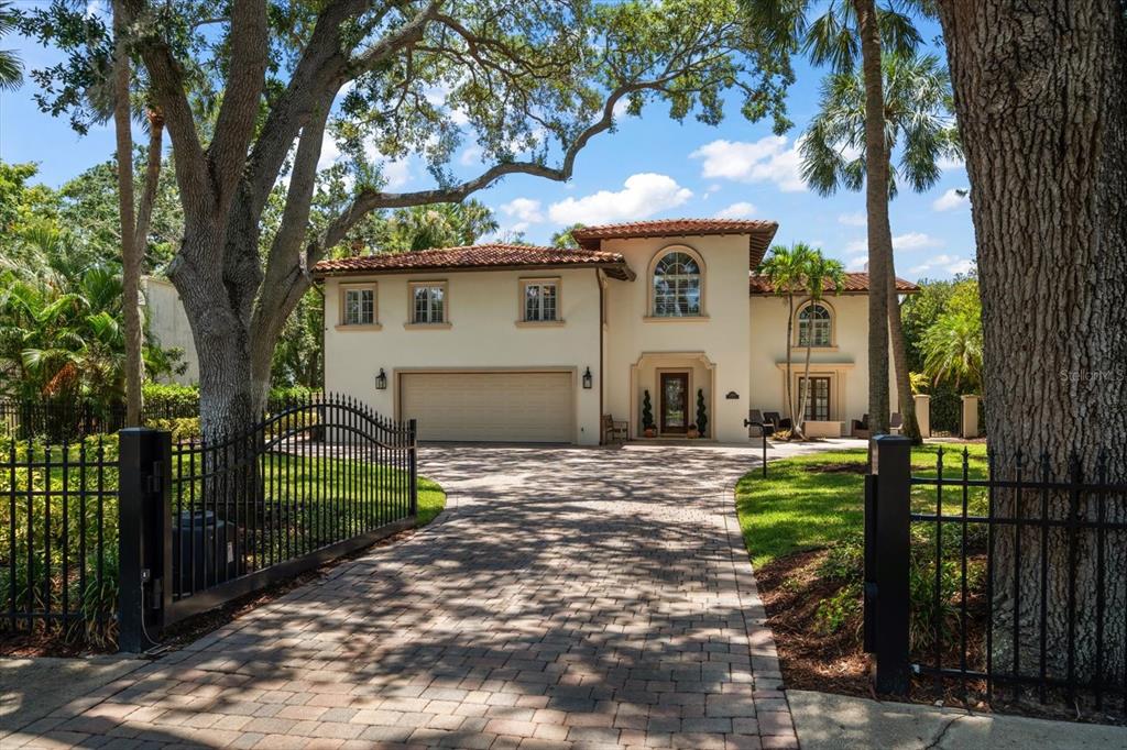 a view of a house with a yard and tree s