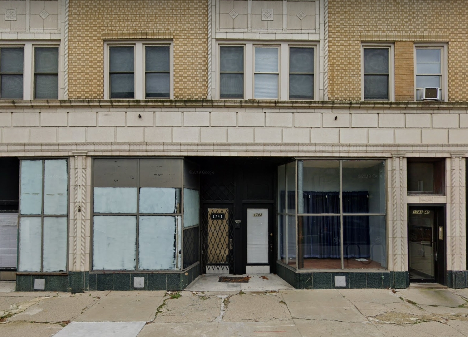 a view of brick building with large windows