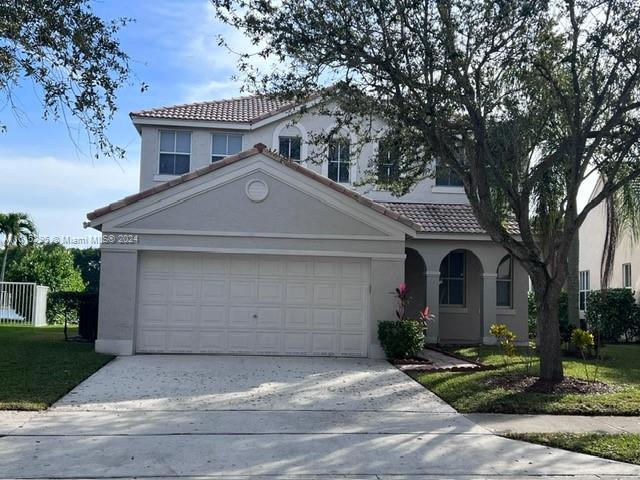 a front view of a house with a yard and garage