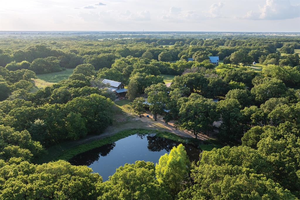 an aerial view of lake residential house with outdoor space and trees