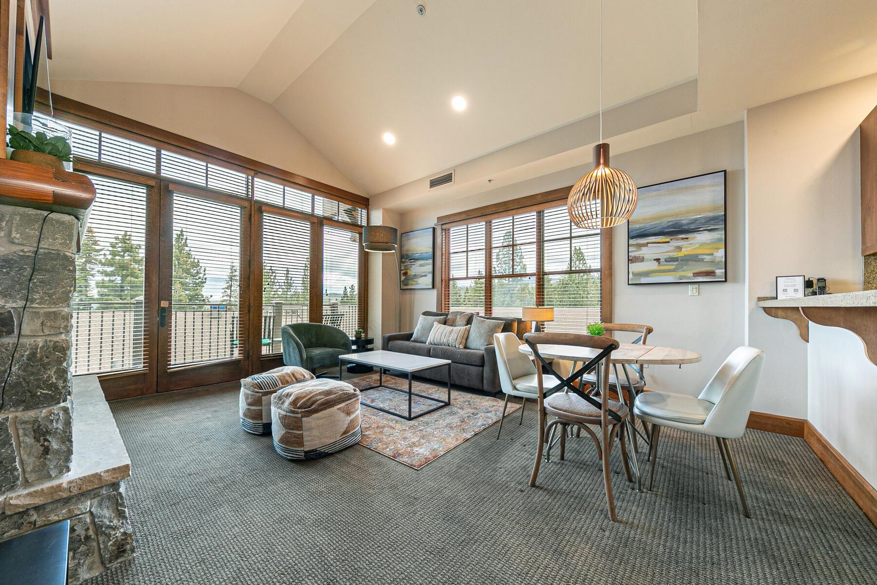 a living room with furniture and large windows