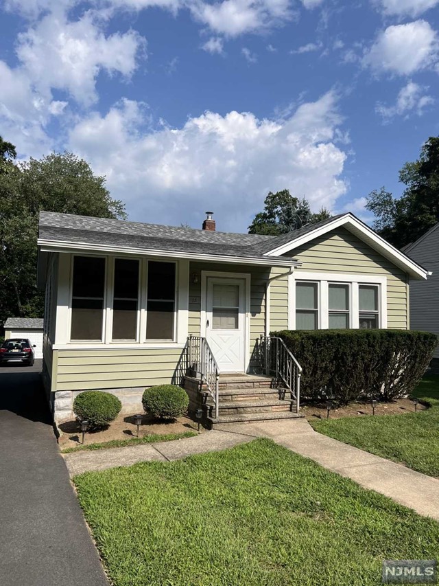 a front view of house with yard outdoor seating and barbeque oven