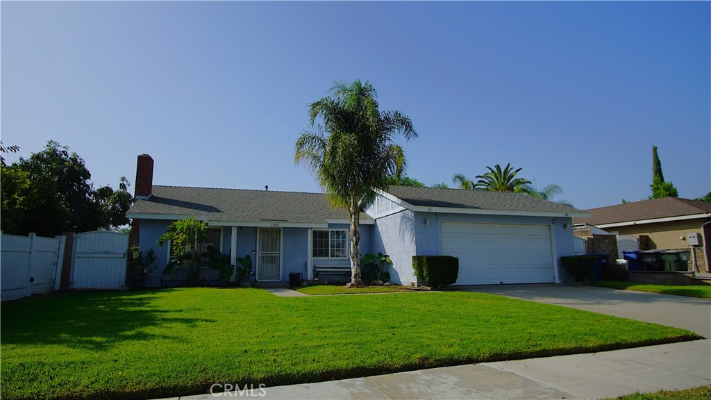 a front view of a house with a garden and yard