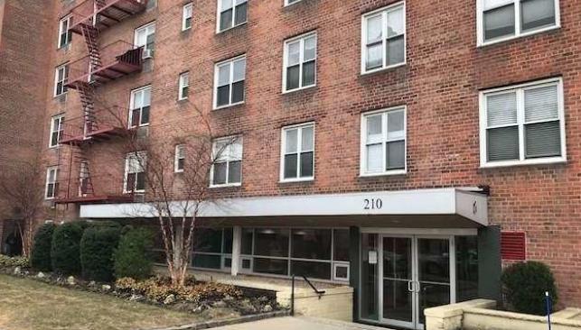 a building view with a large window and a yard balcony