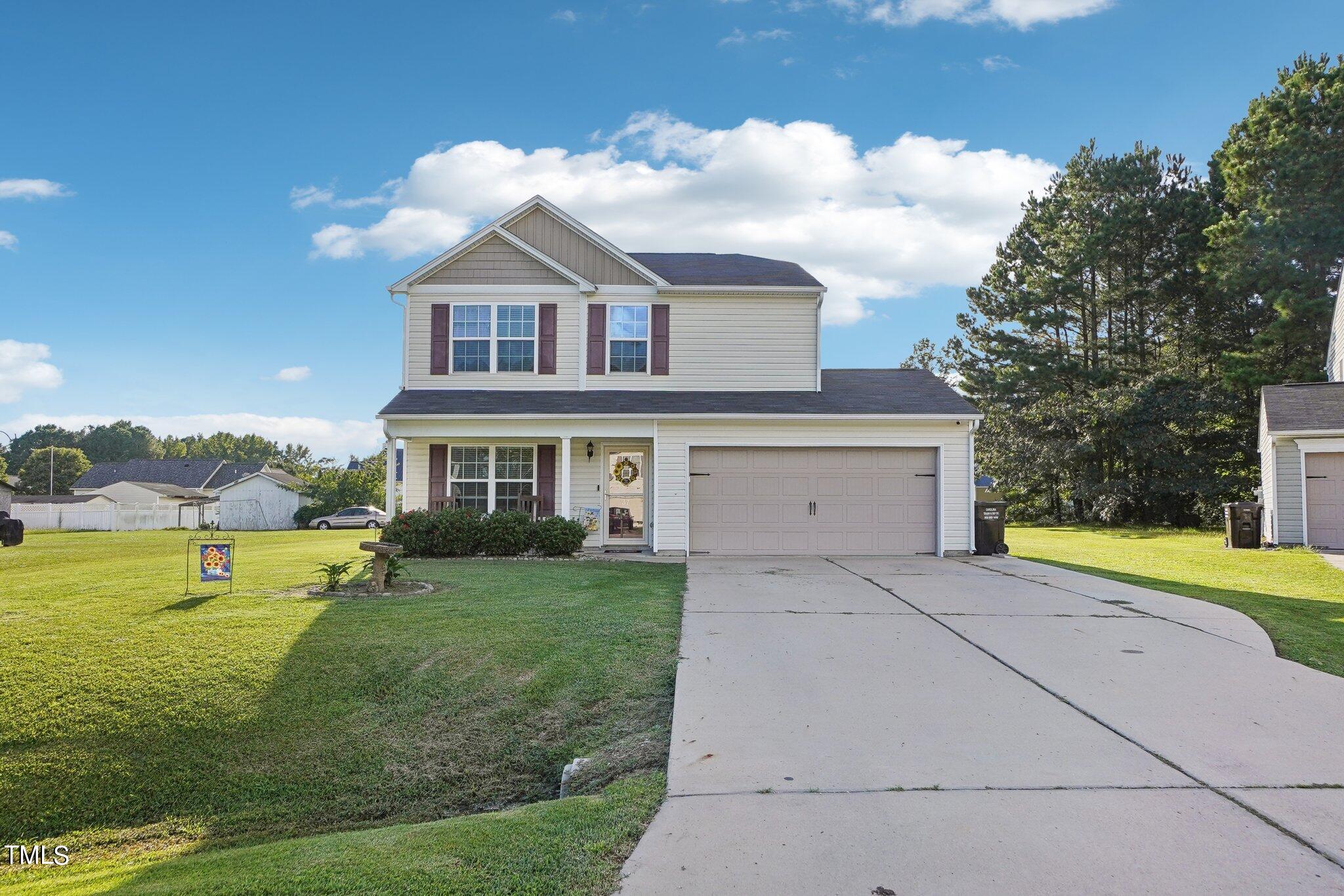 a front view of house with yard and green space