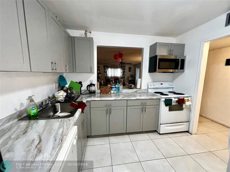 a kitchen with a sink and a stove top oven