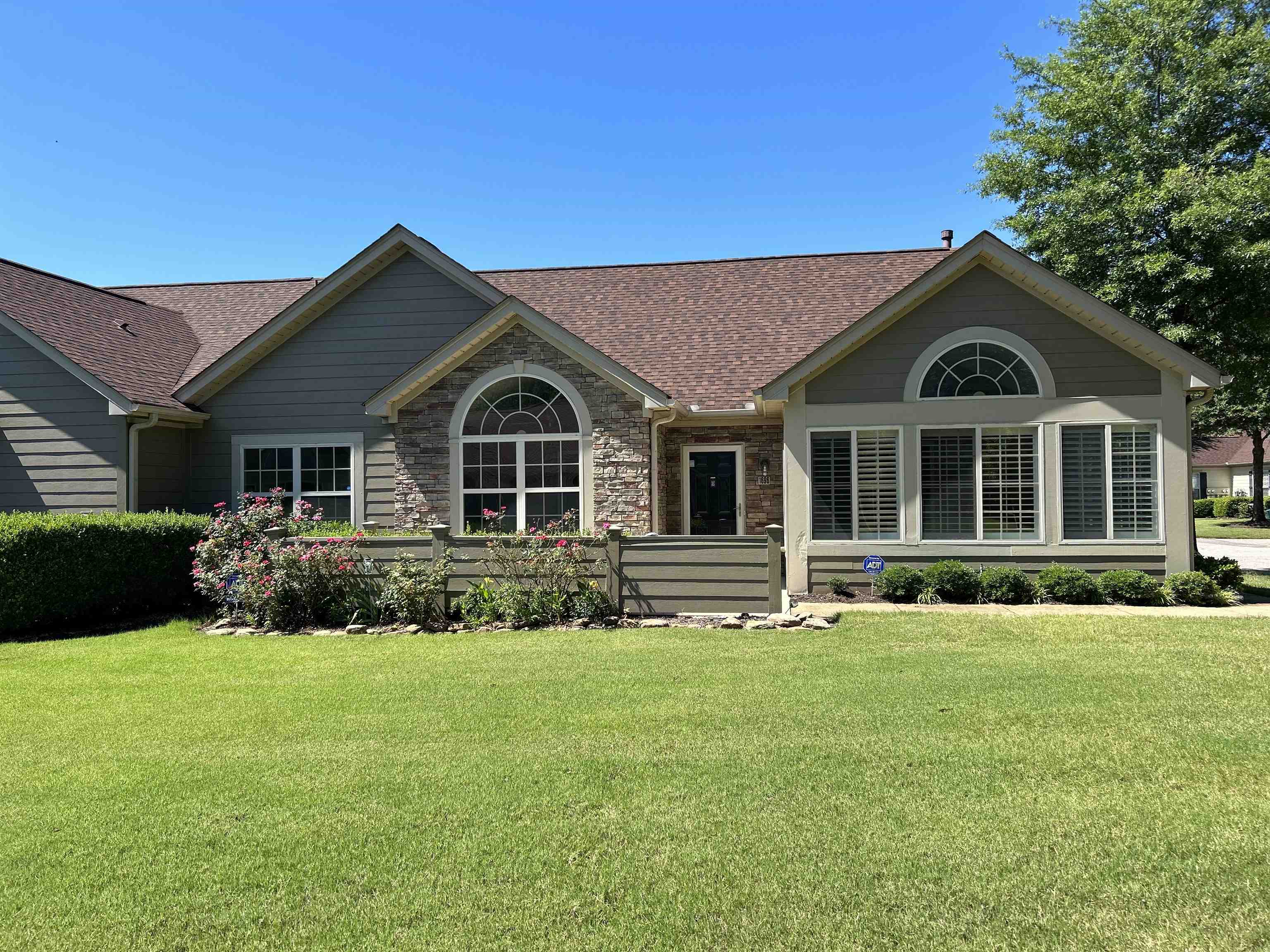 a front view of a house with a yard