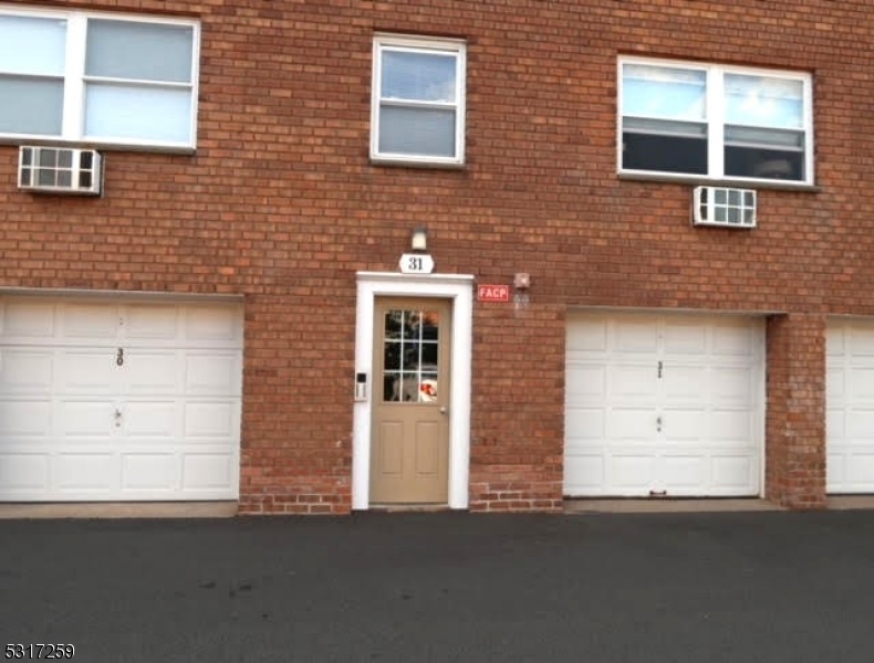 a front view of a building with white doors