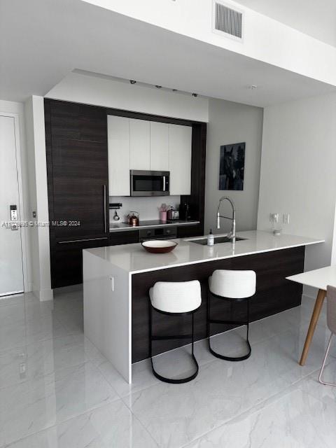 a kitchen with a sink cabinets and appliances