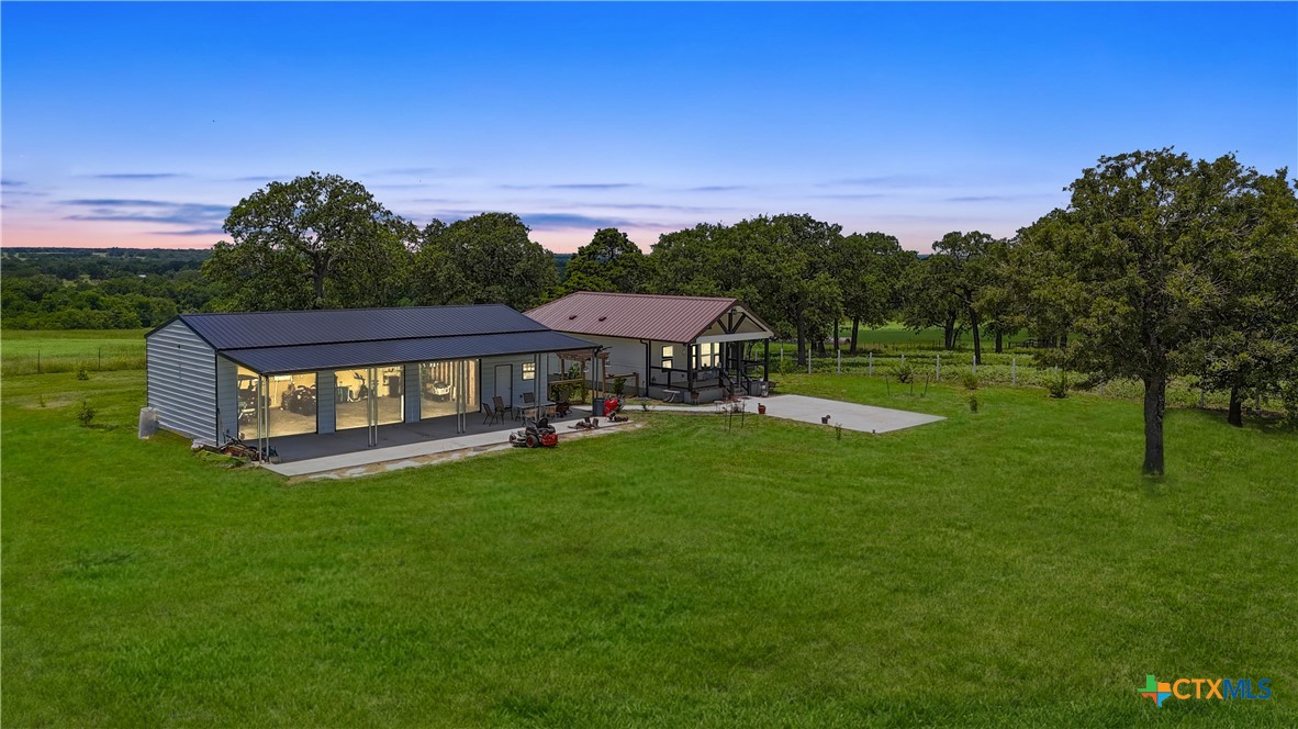 a view of a big house with a big yard