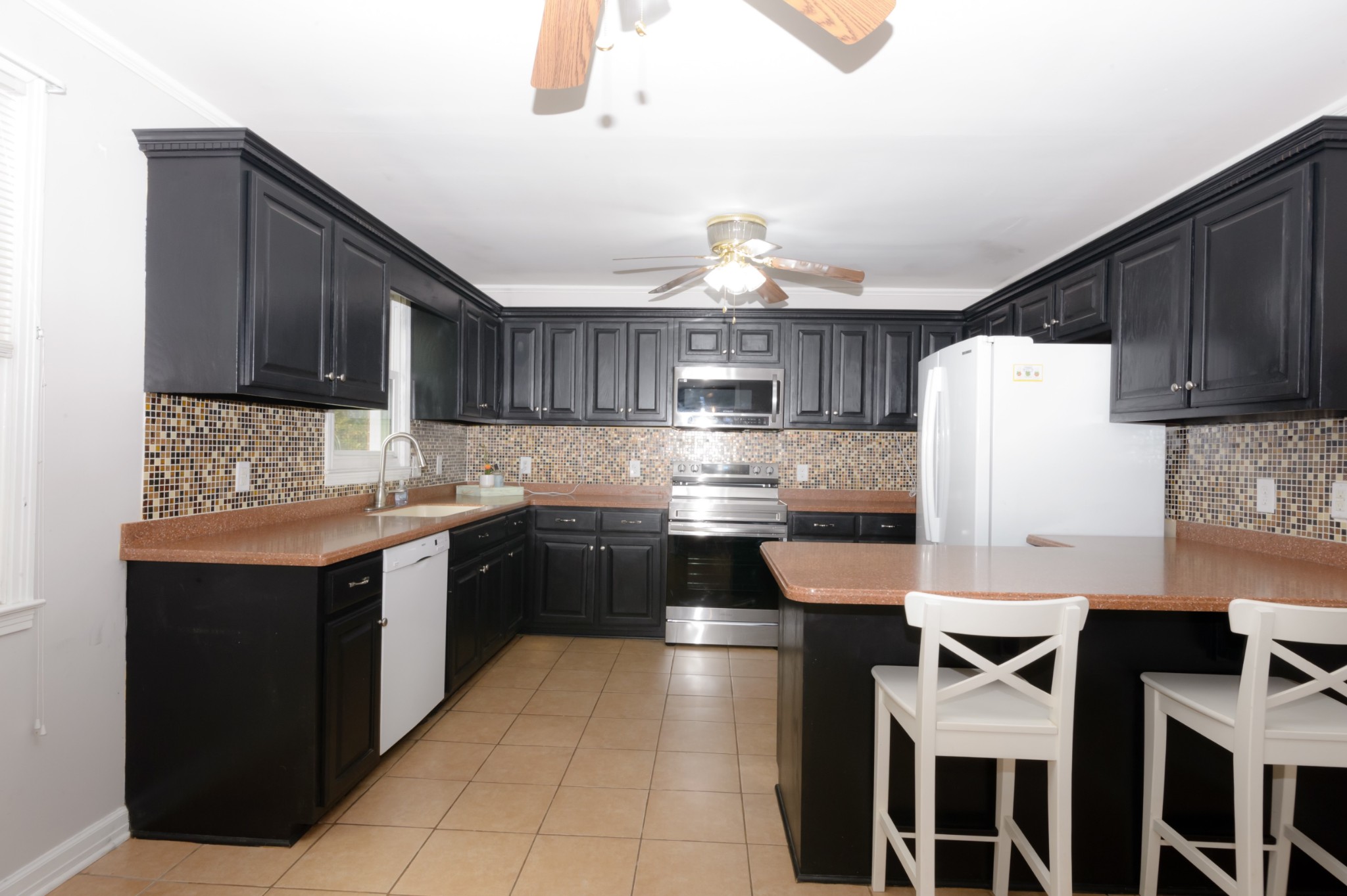 a kitchen with cabinets and stainless steel appliances