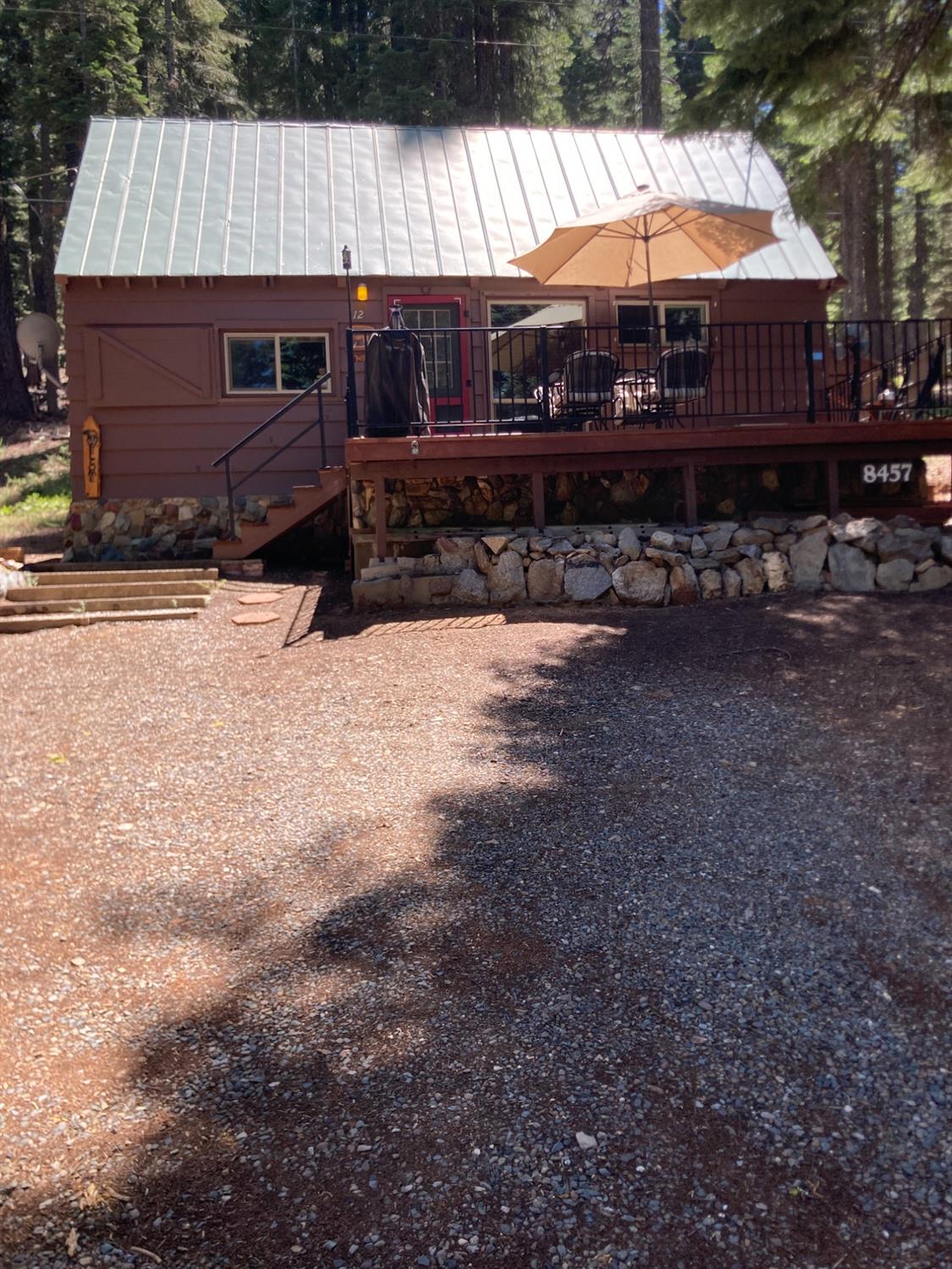 a view of a house with backyard and sitting area