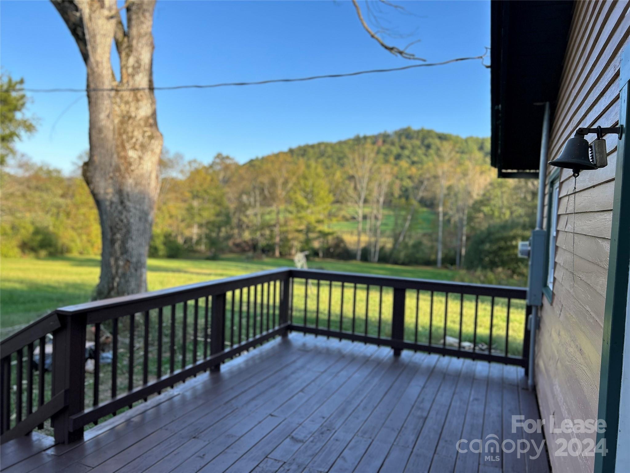 a view of a balcony with a yard