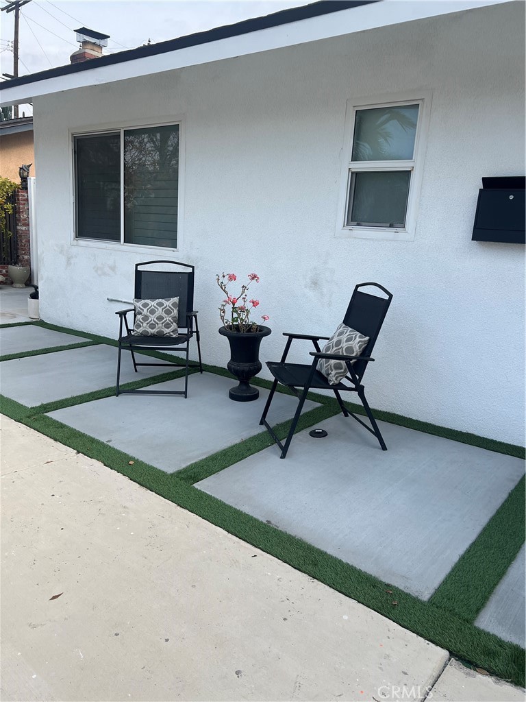 a building outdoor space with patio furniture and a flat screen tv