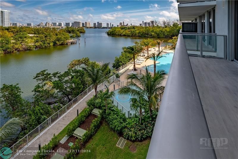 an aerial view of residential houses with outdoor space and lake view