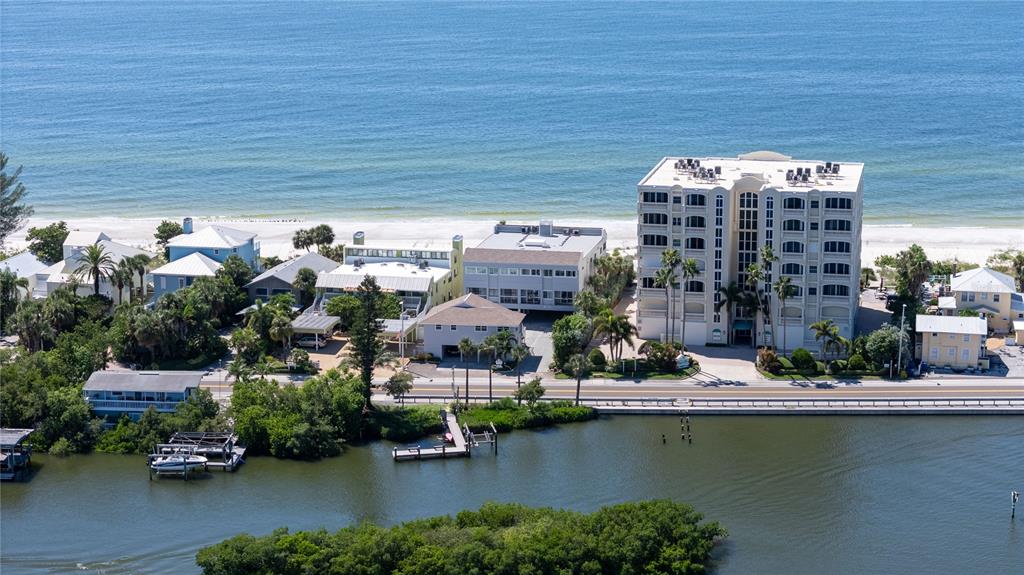 an aerial view of residential houses with outdoor space and swimming pool