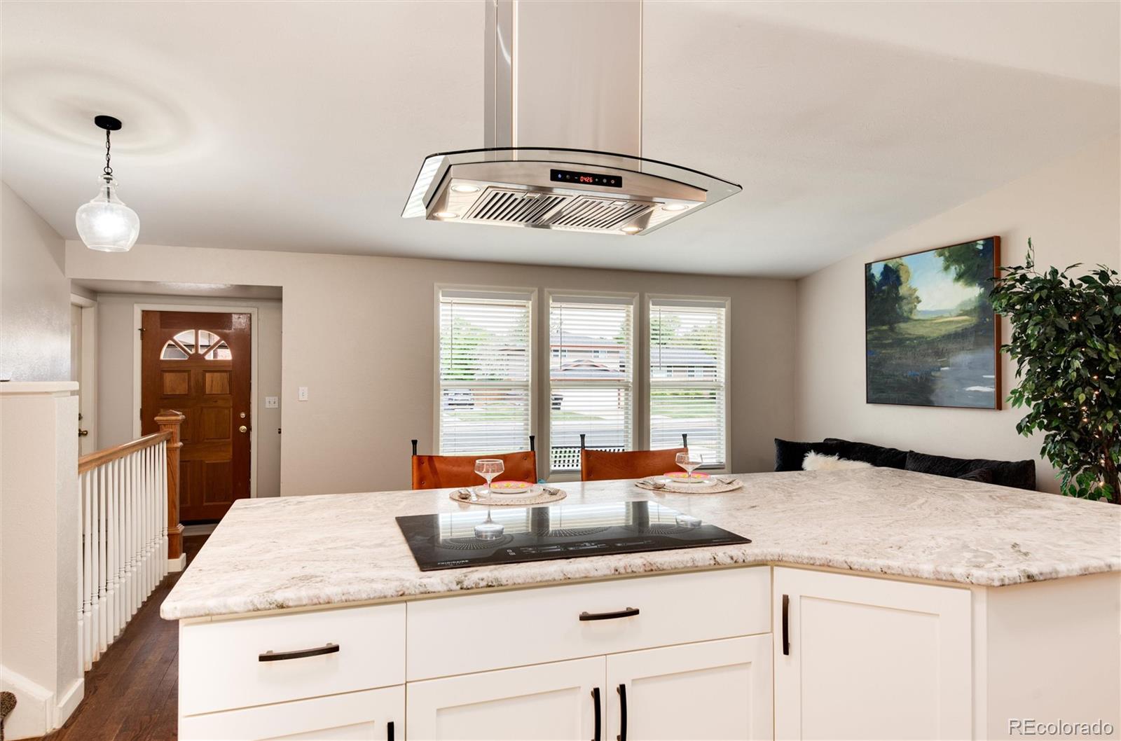 a kitchen with granite countertop a sink and a stove