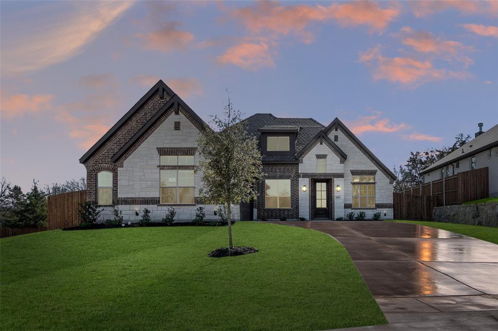 a front view of house with yard and green space