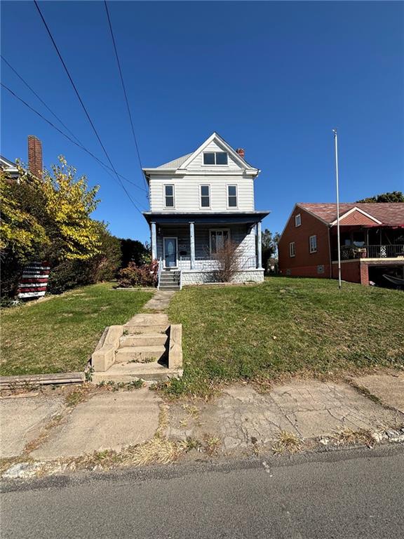 a view of a house with a yard and potted plants