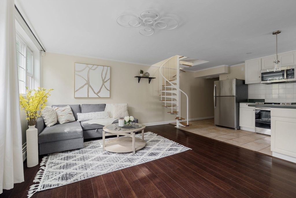 a living room with furniture and kitchen view