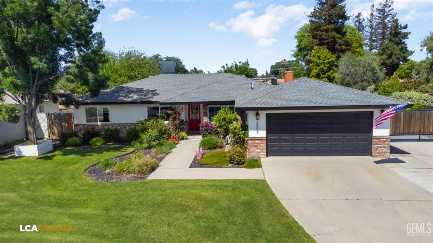 a aerial view of a house with a yard potted plants